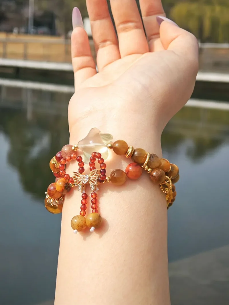 Multi wrap artistic crystal bracelet worn on wrist in warm natural sunlight
