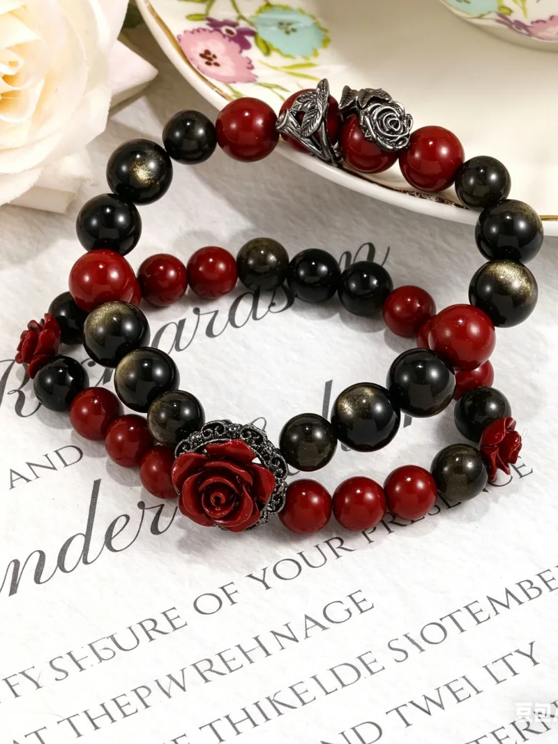 Hand wearing the Rosette Nebula art healing creation featuring cinnabar and golden obsidian stones