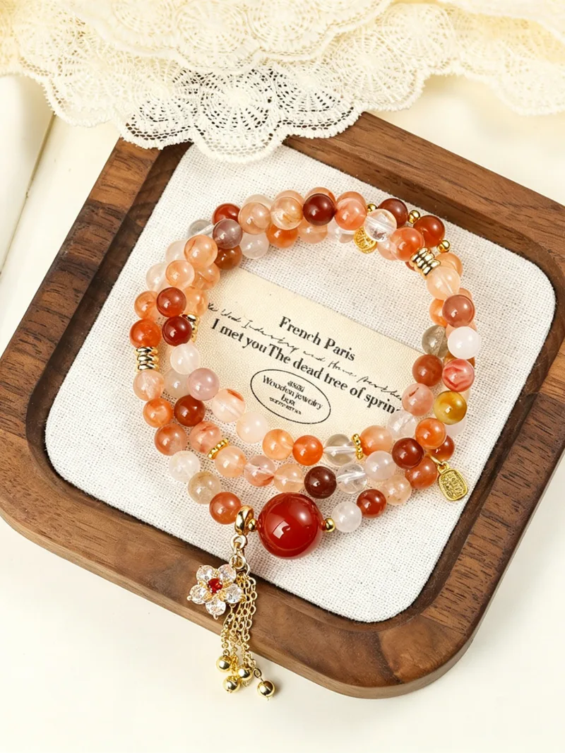 Double wrap artistic crystal bracelet worn on wrist in natural warm light
